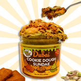 Jar of 'Dubai Cookie Dough Sundae' with a spoonful of cookie dough on a decorative background.